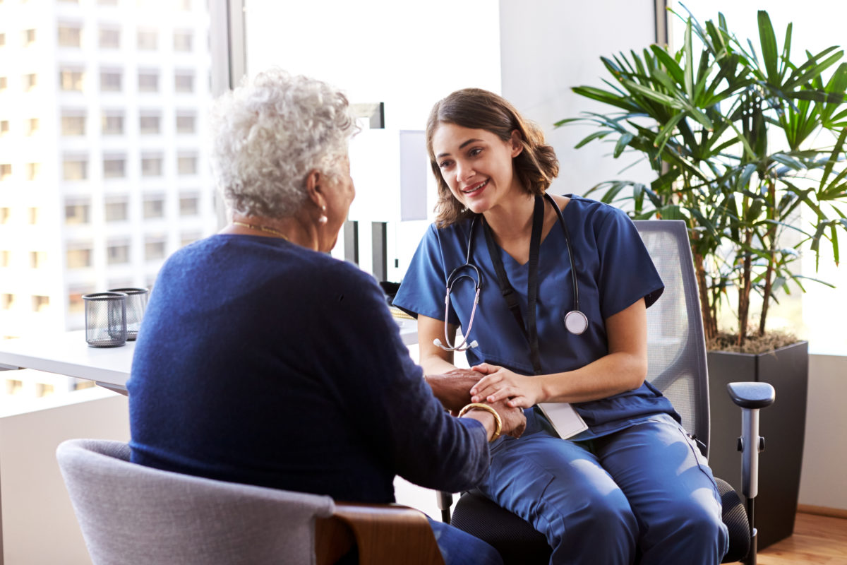 Older patient talks with doctor